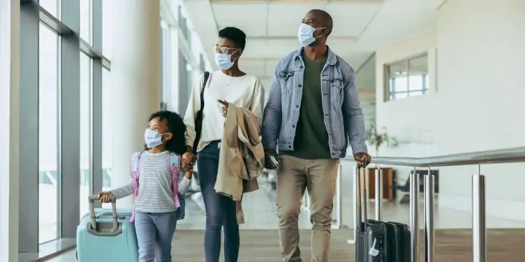 Family wearing face masks in an airport