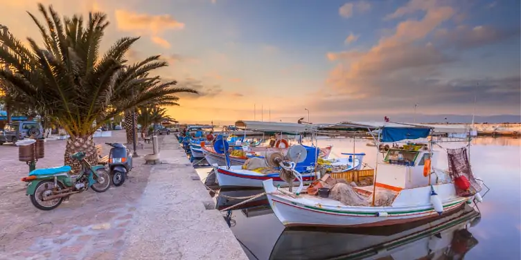 Hydra’s peaceful port with boats and motorbikes