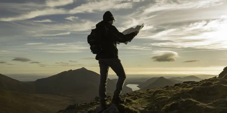 Hiker with map, Mourne Mountains, County Down, Northern Ireland