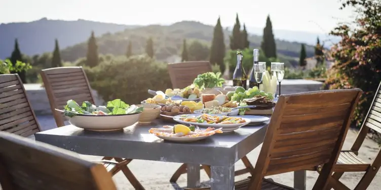 A mediterranean meal set on a table outdoors