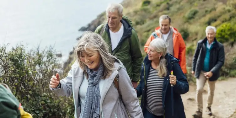 A group of friends take a walk along the coast