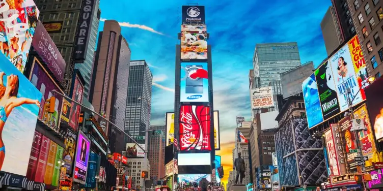 Crowds of tourists gathered in New York’s Time Square surrounded by colourful advertisement boards