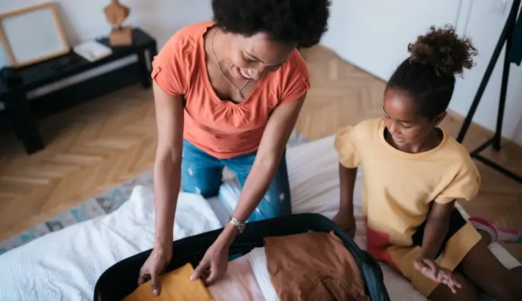 Mother and daughter pack a suitcase together