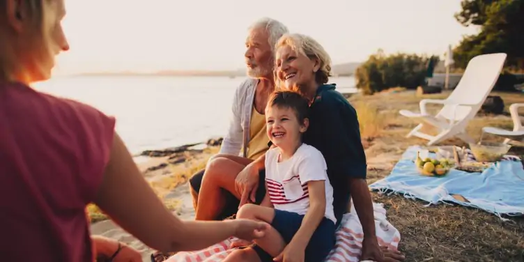 Multi-generation family having a picnic on the beach