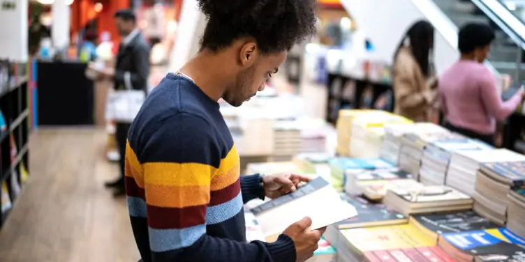 Young man in airport bookstore