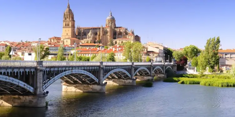 Landscape image of bridge and Salamanca Cathedral on the hill - a UNESCO world heritage listed site