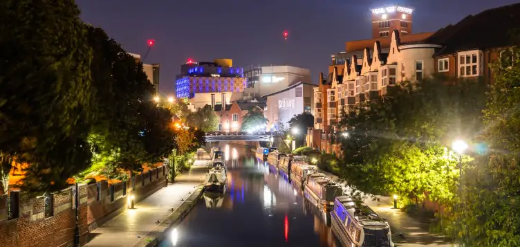 Night time picturesque view of a historic canal in the city centre of Birmingham.