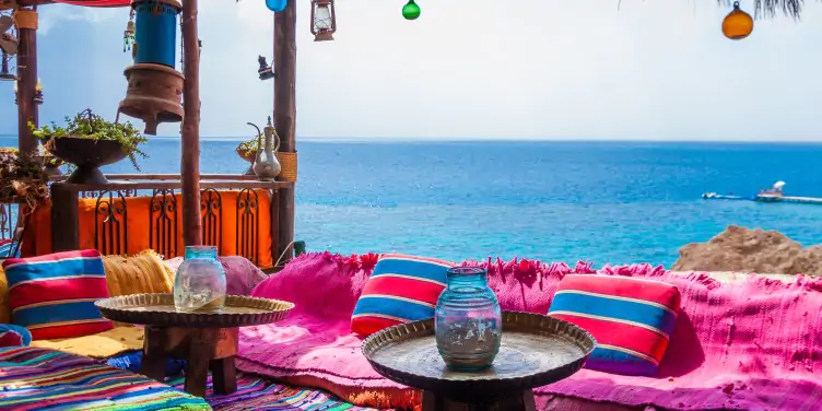 Arabian restaurant overlooking the Red Sea coast, with traditional vibrant Egyptian decorations and colourful cushions. 