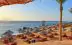 Exotic sandy beach with palm trees and parasols in Sharm el-Sheikh, Egypt