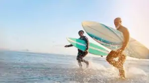 Mature couple surfing at the beach