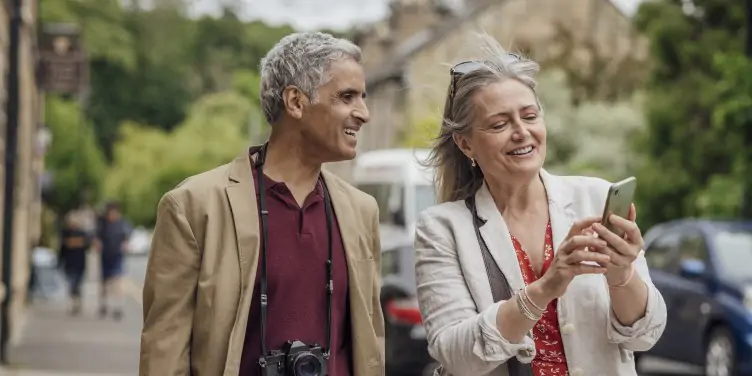 Couple looking at phone for directions. 