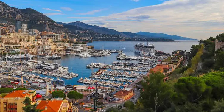 View of Monaco harbour with boats moored up on a bright summers day.