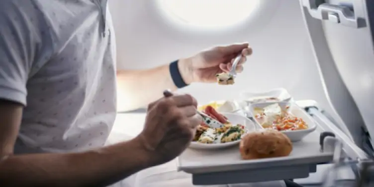 Passenger with food allergies enjoying a meal on their long-haul flight. 