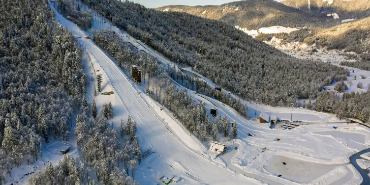Bird's eye view of a large ski run on a bright wintery day at a unique ski resort in Slovenia. 