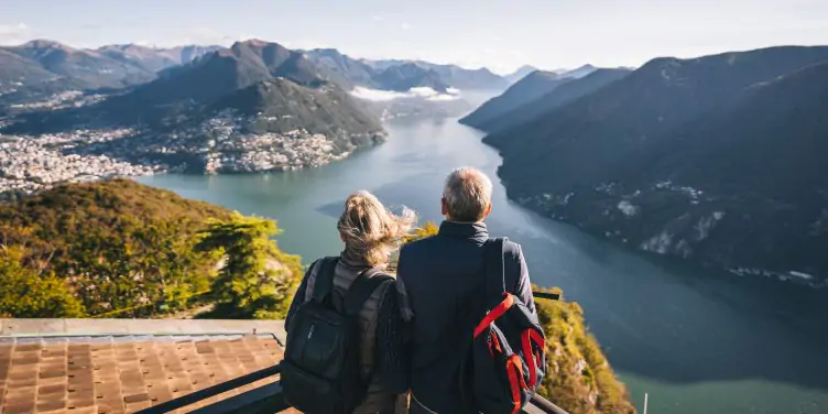 Senior couple leaving for holiday with luggage