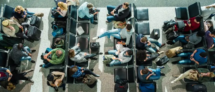 people waiting at airport in departure lounge